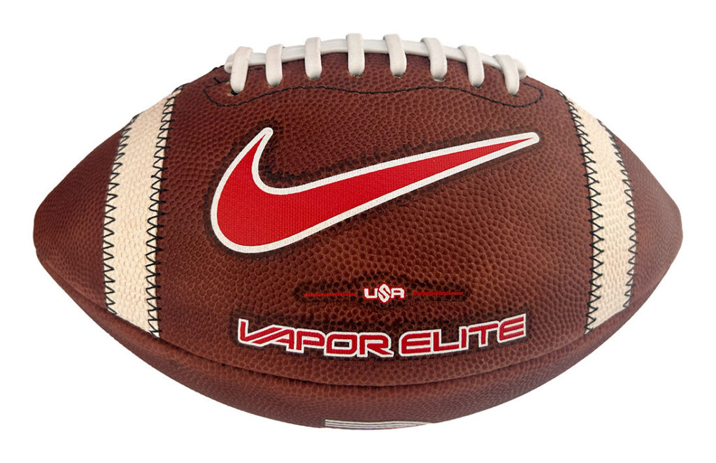Nike Vapor Elite football: brown leather with white laces, red swoosh, and 'Vapor Elite' branding visible.
