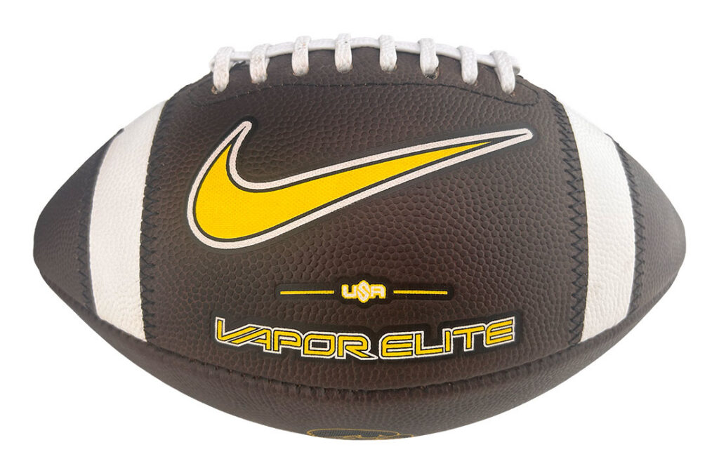 Brown and white leather football featuring a prominent yellow Nike swoosh and Vapor Elite branding. Butyl laces visible on top.