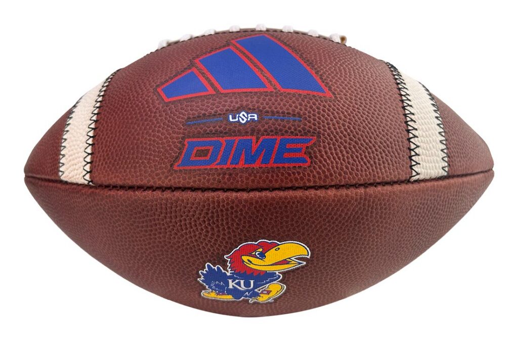 Brown basketball with KU Jayhawks logo and blue-red DIME branding, close-up of stitching and panels in white and brown tones.