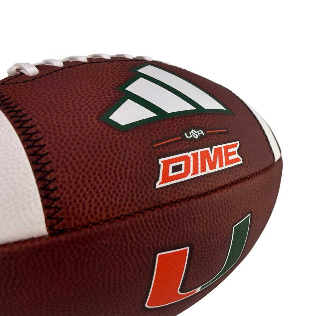 Close-up of a brown football with white laces, featuring a green-and-white logo and the red DIME branding (USA).