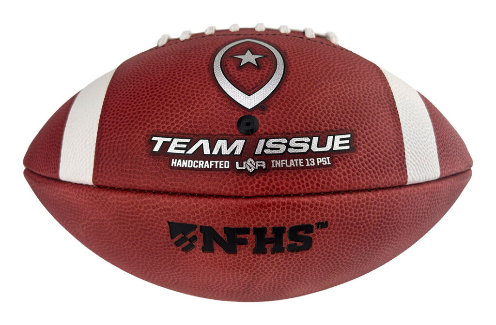 Red football with white stripes and embossed logos, including 'TEAM ISSUE' and 'NFHS' branding; shows a handcrafted, USA-inflated ball.