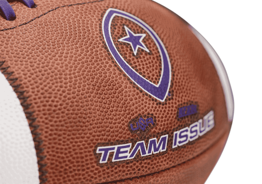 edited Close up image of Team Issue football with purple laces and lettering