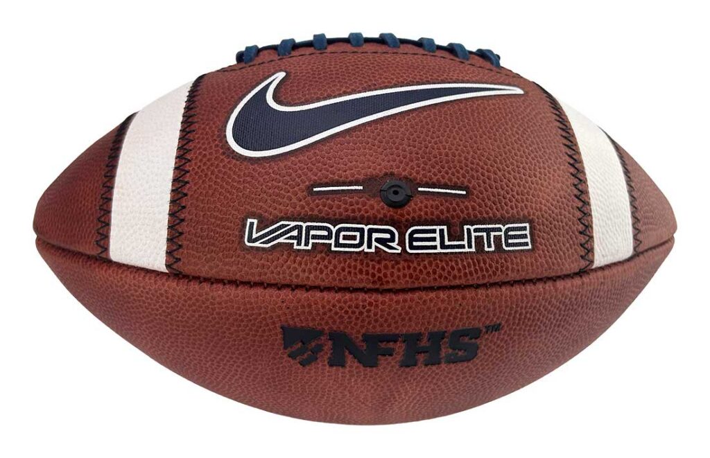 American football ball with Nike swoosh, Vapor Elite branding and NFHS logo on brown leather with white stripes
