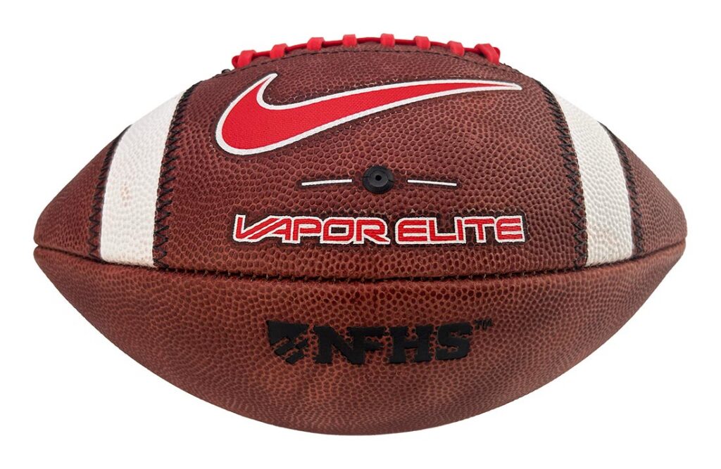 Brown leather football with white stripes, red laces, Nike swoosh, and 'Vapor Elite' branding.