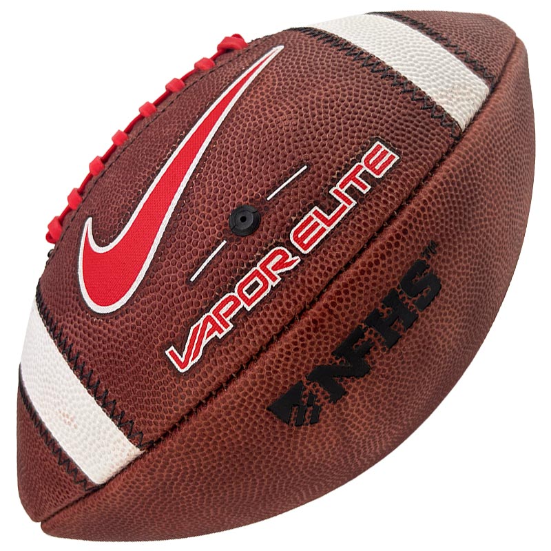 Brown American football with white laces and white stripes, featuring a red Nike swoosh and 'VAPOR ELITE' branding.