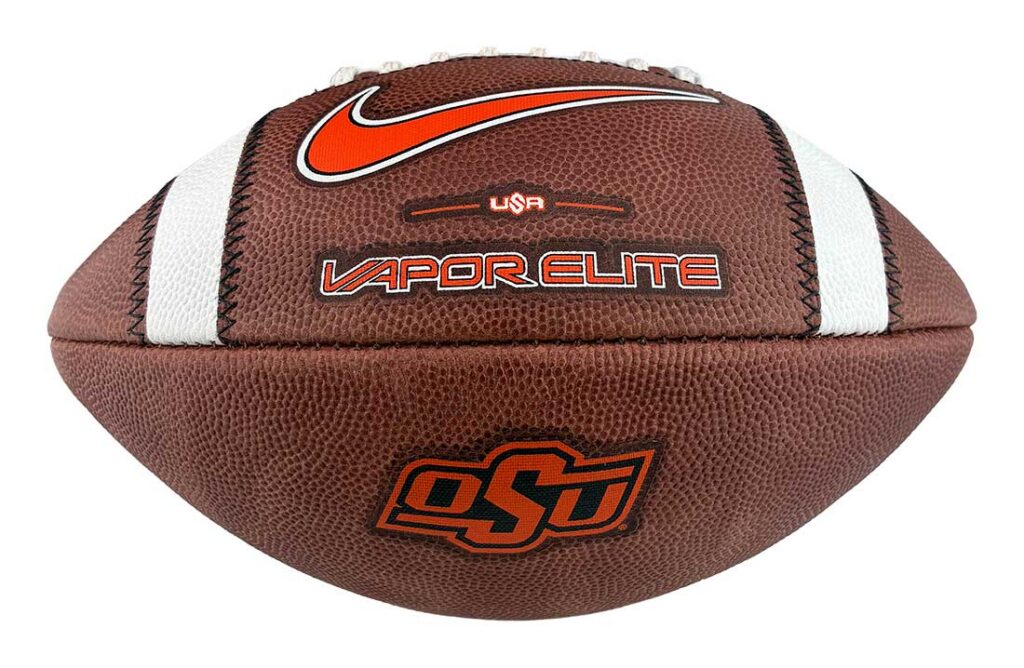 Brown leather American football with white laces and stripes, featuring the OSU logo and the 'Vapor Elite' branding with an orange Nike swoosh.