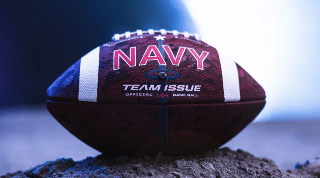 Official Team Issue Navy football on pile of rocks
