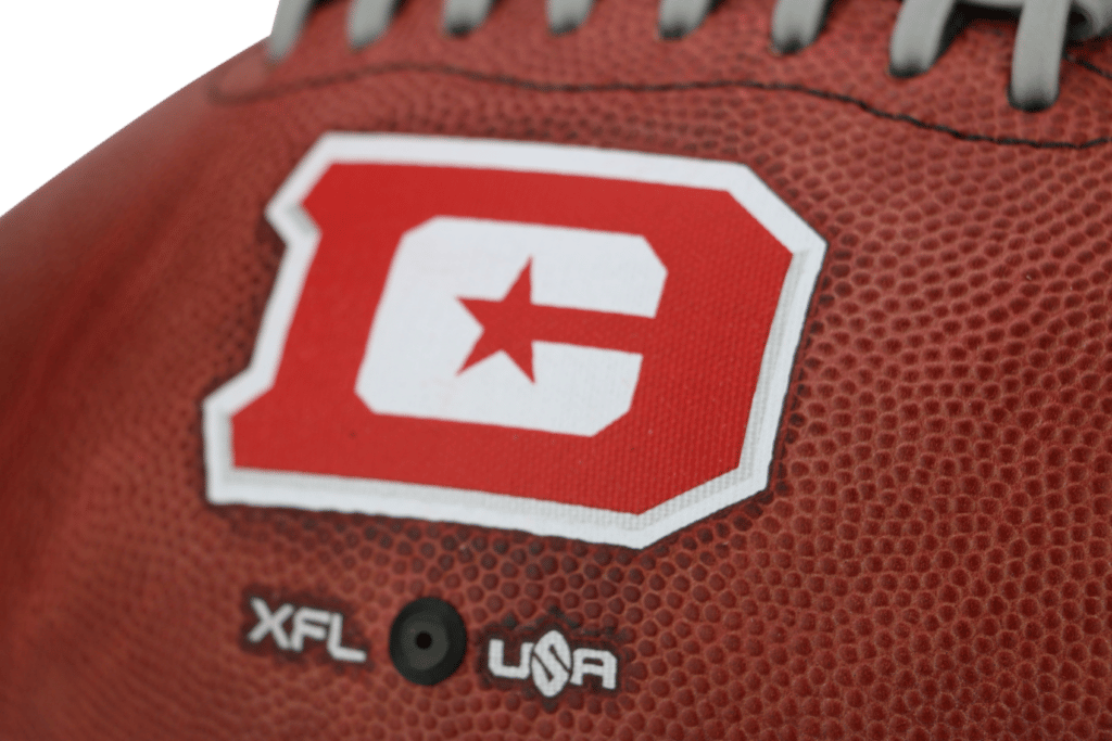 Close up of red and white D.C. Defenders logo on football for XFL