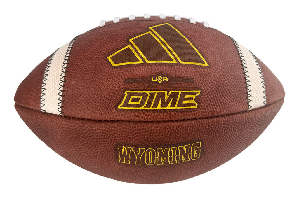 Brown football with white laces, gold lettering saying WYOMING and a yellow logo above, plus a small USA and DIME branding on the panel