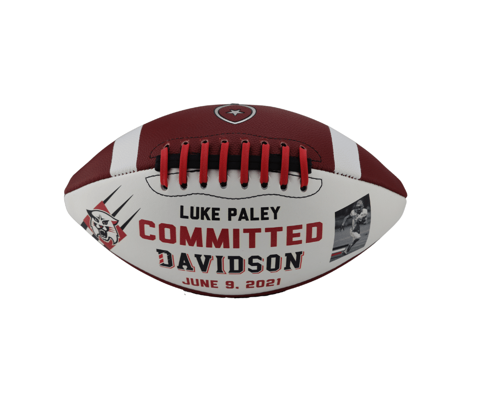 commemorative football that is customized with school colors of white and red