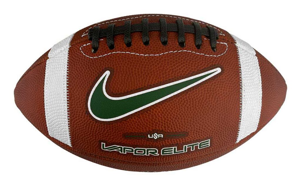 Brown football with white laces and stripes, green Nike swoosh, and 'Vapor Elite' branding in green text on the side.