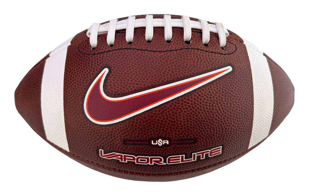 Brown leather football with white laces and a red Nike swoosh logo, close-up product shot on white background.
