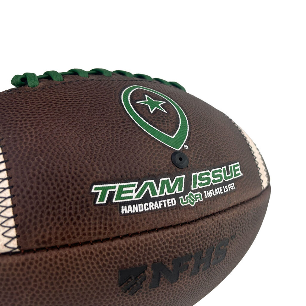 Brown football close-up with green laces and Team Issue logo, plus USA and 'INFLATE 13 PSI' text near the seam.