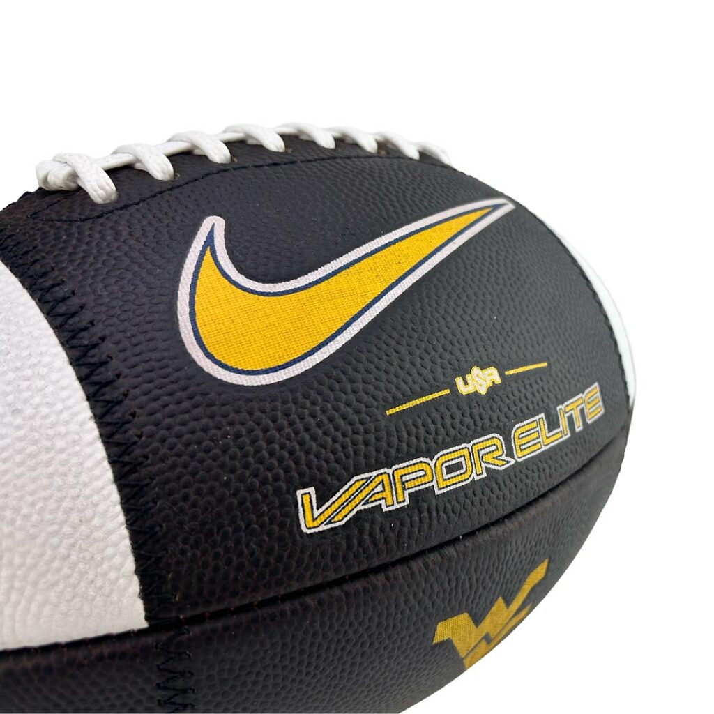 Close-up of a black football with a yellow Nike swoosh and 'VAPOR ELITE' branding in yellow text