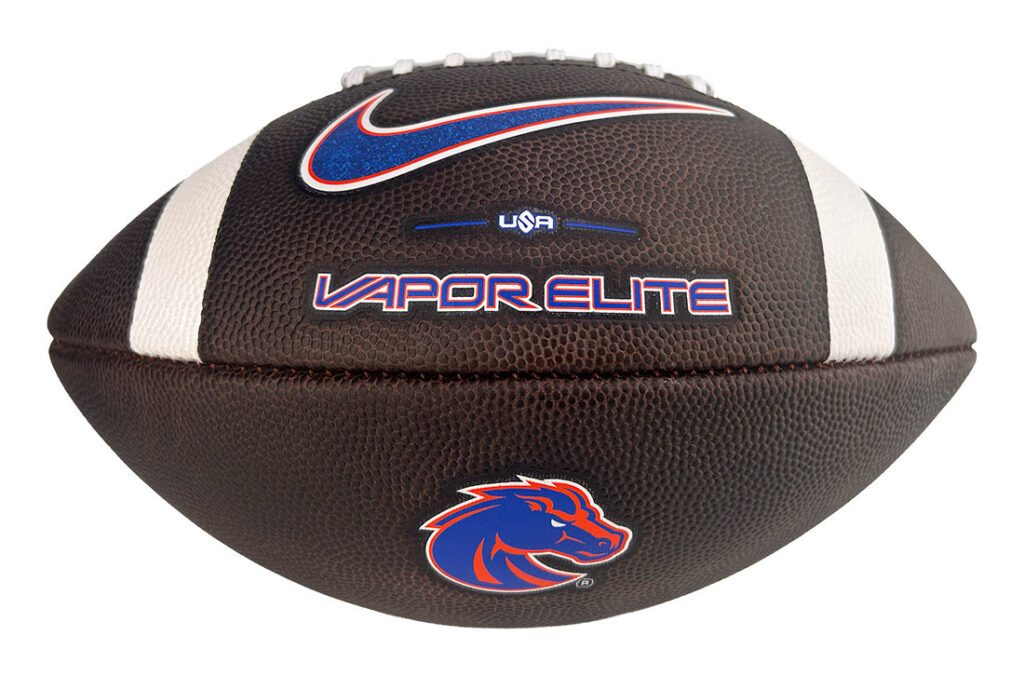 Brown leather football with white laces featuring Vapor Elite branding, a blue Nike swoosh, USA text, and a Boise State Broncos logo on the side.
