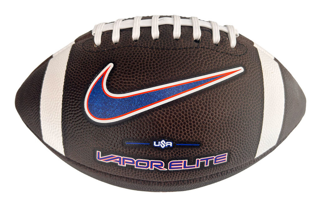 Brown leather football with white laces and a blue Nike swoosh logo, 'USA' and 'LAPOR ELITE' branding visible on the ball