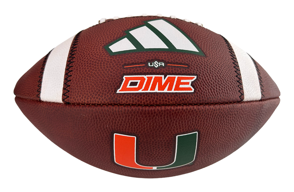 Close-up of a brown football with white laces and logos: USA, DIME, and the Miami Hurricanes U symbol.