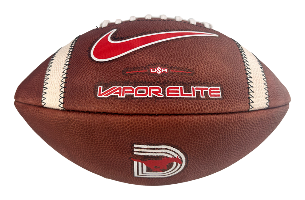 Brown leather football with white laces and a red Nike swoosh, showing 'USA' and 'VAPOR ELITE' branding.