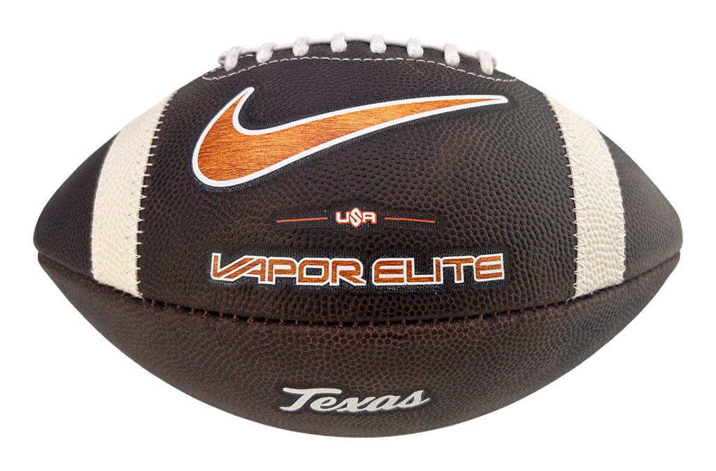 Brown leather American football with white laces and orange Nike swoosh, labeled Vapor Elite with 'Texas' script nearby.
