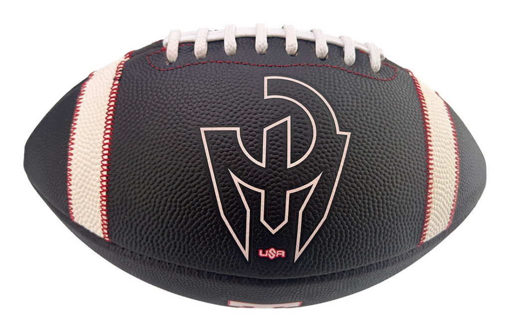Black pebbled football with white laces and red stitching, featuring a large pale logo emblem on the side (product shot).