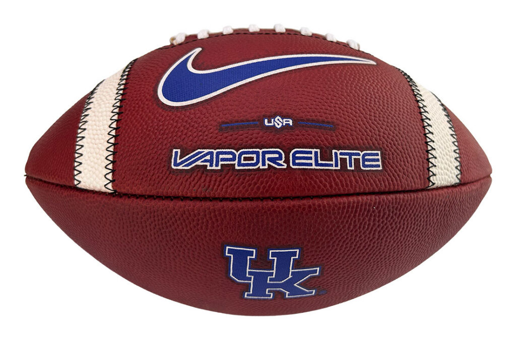Football with UK logo and Nike swoosh, labeled Vapor Elite USA on a brown leather ball.