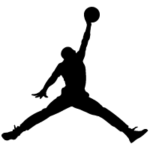 Silhouette of a basketball player jumping to dunk a ball on one arm upraised.
